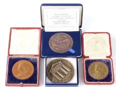 Four cased bronze medal coins to include 1837-1897 Victoria Jubilee, 1911 Coronation medal, Lifeboat