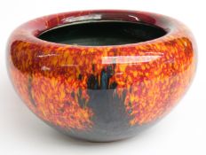 Poole Studio bowl with curled rim decorated with a flecked orange and red glaze, H7cm,D29cm