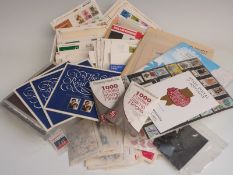 A box of presentation packs and first day covers together with a box of sundries