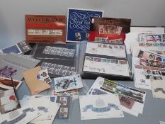 An album of first day covers, a quantity of mint GB stamps and commemorative booklets