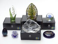 Seven glass paperweights comprising four Mats Jonasson for Maleras of Sweden, all in original boxes,