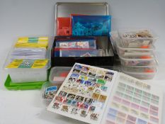 A stockbook of mint stamps and a large quantity of loose all-world stamps in plastic boxes