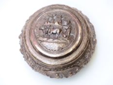 Chinese or Burmese white metal lidded pot with embossed figural scenes and oxen ploughing field to