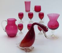 Eleven pieces of cranberry glass including jug, vase, duck etc, largest piece 21cm tall