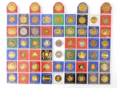 Over 50 largely gold plated medallion coins representing architecture of Great Britain etc