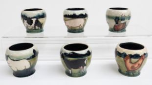 Six Moorcroft egg cups decorated with farm animals and birds, H4.5cm