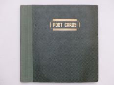 A postcard album containing humorous, topographical, shipping and embroidered Spanish cards