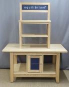 A pine or similar shop display stand with two shelves above the top, the base fitted cupboards and