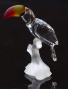 Swarovski glass toucan with cut glass body and coloured eyes and beak on frosted naturalistic
