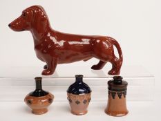 Three pieces of miniature Doulton stoneware and a Beswick dog, tallest 14cm