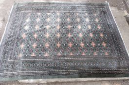 Green ground rug with repeating central design and borders, 320x246cm