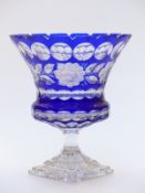 Flash overlaid cut glass chalice decorated with flowers and blue overlay over clear ground, raised