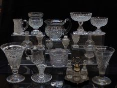 Over 50 pieces of cut glassware including cruet sets, vases, tazzas, decanters, goblets etc.