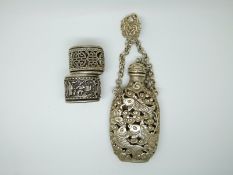 Chinese white metal snuff bottle on chain, with four character mark to base and clip with fish and