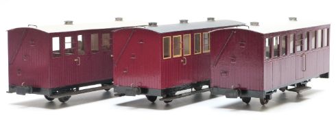A rake of three 32mm gauge garden railway matchboard passenger coaches, one with guard's