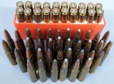 Fifty seven .308 rifle cartridges, some in a cartridge holder. PLEASE NOTE THAT A VALID RELEVANT