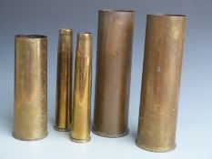 Five brass shells, 2 x 40mm, 2 x 105mm and one other