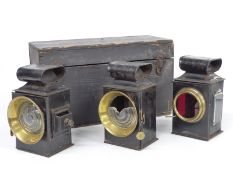 A boxed set of three early motor car, veteran car or steam engine oil lamps comprising two front and
