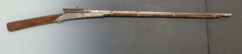 Middle Eastern matchlock gun with riveted steel lock plates, brass bands, stock stamped 357 and 40