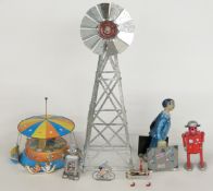 Six clockwork and mechanical tinplate toys including two robots, carousel etc together with a