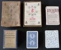 Various English playing card games including five-suit bridge cards, 65 cards, joker and rules in