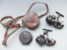 Two Mitchell 206 and 208 fixed spool fishing reels and a vintage leather reel case with fly
