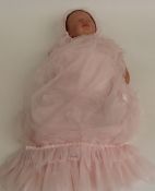 Laura Tuzio-Ross Reborn silicone doll with closed mouth and eyes and brown hair, marked to the