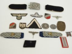 A small collection of WWII Nazi German badges and cloth insignia including a Waffen SS