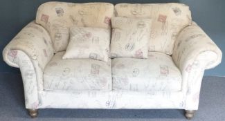 Beige upholstered two seater sofa