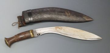 Kukri knife with 27cm curved blade, in leather sheath.