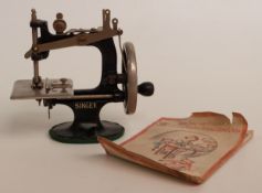 Child's Singer miniature sewing machine with original booklet