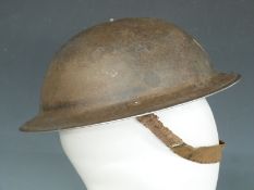 British Army WWII 'Brodie' steel helmet with liner and chin strap, the rim stamped 1939