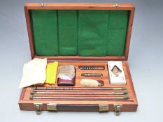 Elvicta 12 bore shotgun cleaning kit in fitted wooden case with carry handle.