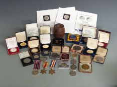 Collection of military related commemorative coins and medallions including Spink 1916 Battle of