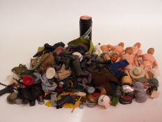 Five vintage Action Man figures together with a large collection of clothes and accesseries