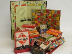 A collection of vintage games including Blow Football, Snakes and Ladders, Monopoly, Roots, dominoes