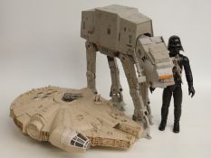 Three Star Wars action figures and vehicles comprising Darth Vader Millennium Falcon and AT-AT