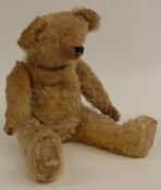 A vintage mohair teddy bear with shaved pointed snout, humped back, cocked feet and wrists,