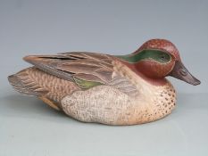 Wooden Green Winged Teal duck decoy with with painted feathers and glass eyes, signed to the base '