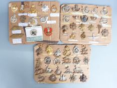 British Army collection of cap badges including School of Small Arms, Royal Devon Militia, Royal