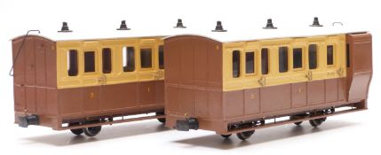 A pair of 32mm gauge garden railway passenger coaches in brown and cream livery, one with guard's
