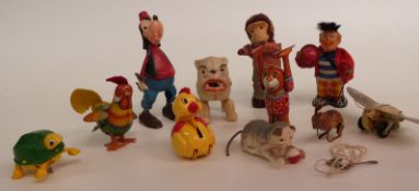 Eleven clockwork tinplate and plastic toys, including Disney Goofy, monkey, cats etc.