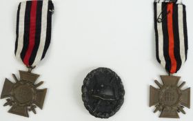 WWII Nazi Third Reich German collector's card book, two replica medals and a cap badge