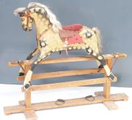 Vintage rocking horse with dappled decoration and upholstered saddle on wooden base, height 91cm,
