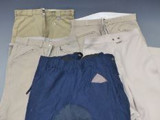 Four pairs of 32in waist breeches/jodhpurs and a pair of riding overtrousers