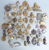 A collection of British Army cap badges including Royal Engineers, Royal Artillery, Intelligence