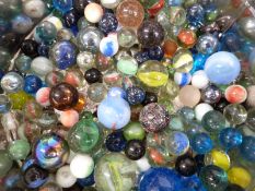 A large collection of glass marbles including clear and multi-coloured examples.