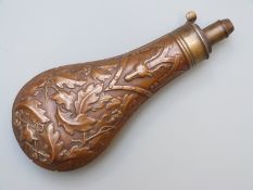G & J.W. Hawksley copper and brass powder flask with embossed decoration of foxes, stags and oak