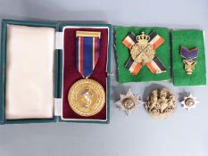 A small collection of militaria comprising Irish Guards officer's white metal and enamel rank
