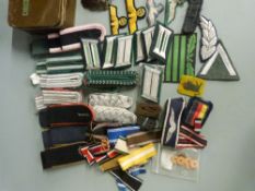 A quantity of German, American and British WWII militaria including shoulder boards, pins etc in a